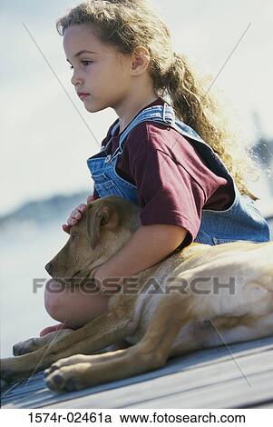 Side profile of a girl sitting with her dog View Large Photo Image Stock Image - Side profile of a girl sitting with her dog. Fotosearch
