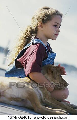 Side profile of a girl sitting with her dog View Large Photo Image Stock Image - Side profile of a girl sitting with her dog. Fotosearch
