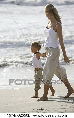 Side profile of a mother and her daughter walking on the beach View Large Photo Image Stock Image - Side profile of a mother and her daughter walking on the beach. Fotosearch