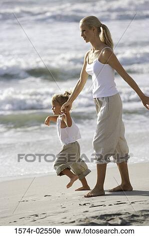 Side profile of a mother and her daughter walking on the beach View Large Photo Image Stock Image - Side profile of a mother and her daughter walking on the beach. Fotosearch