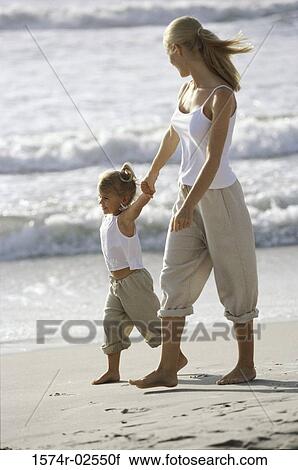 Side profile of a mother and her daughter walking on the beach View Large Photo Image Stock Image - Side profile of a mother and her daughter walking on the beach. Fotosearch