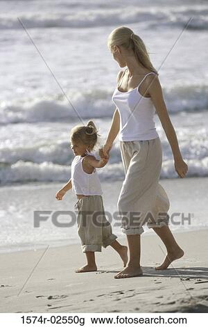 Side profile of a mother and her daughter walking on the beach View Large Photo Image Stock Image - Side profile of a mother and her daughter walking on the beach. Fotosearch