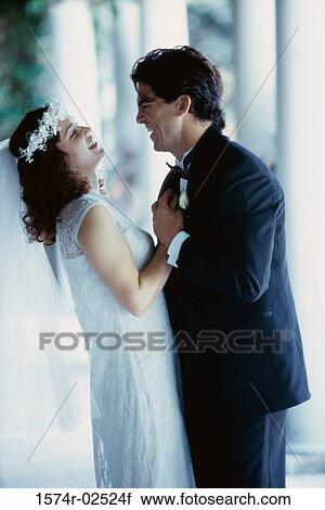 Side profile of a newlywed couple laughing View Large Photo Image Stock Image - Side profile of a newlywed couple laughing. Fotosearch