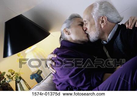 Stock Image - Side profile of a senior couple kissing. Fotosearch