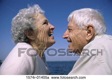 Stock Image - Side profile of a senior couple laughing. Fotosearch