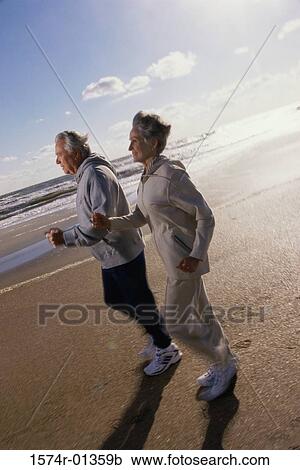 Side profile of a senior couple running at the beach View Large Photo Image Stock Image - Side profile of a senior couple running at the beach. Fotosearch