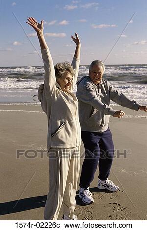 Side profile of a senior couple exercising on the beach View Large Photo Image Stock Image - Side profile of a senior couple exercising on the beach. Fotosearch