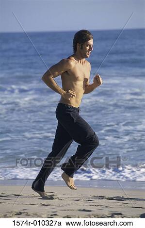 Side profile of a young man running at the beach View Large Photo Image Stock Image - Side profile of a young man running at the beach. Fotosearch