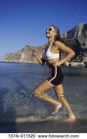 Side profile of a young woman running on the beach View Large Photo Image Stock Image - Side profile of a young woman running on the beach. Fotosearch
