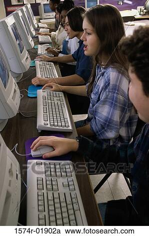 Side profile of group of teenage students using computers in a classroom View Large Photo Image Stock Image - Side profile of group of teenage students using computers in a classroom. Fotosearch