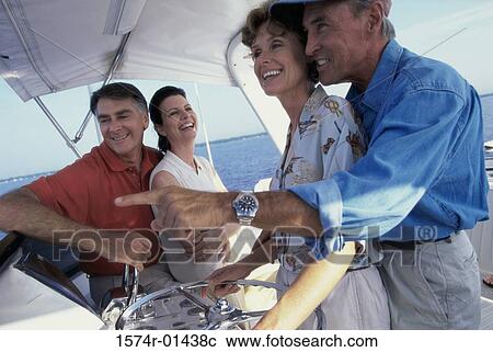 Side profile of two mature couples on a boat View Large Photo Image Stock Image - Side profile of two mature couples on a boat. Fotosearch