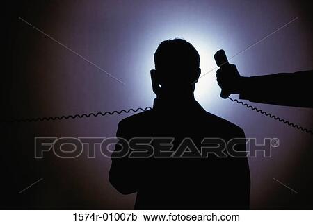 Silhouette of a businessman talking on a telephone View Large Photo Image Stock Image - Silhouette of a businessman talking on a telephone. Fotosearch