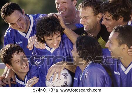 Stock Image - Soccer team laughing together. Fotosearch