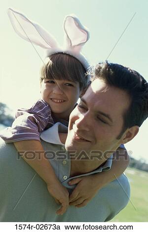 Son riding piggyback on his father View Large Photo Image Stock Image - Son riding piggyback on his father. Fotosearch