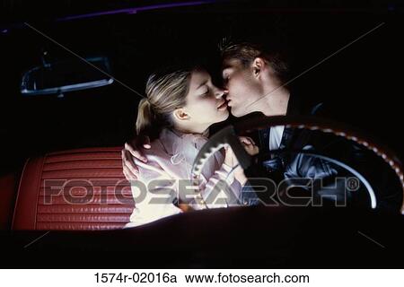 Teenage couple sitting in a car kissing View Large Photo Image Stock Image - Teenage couple sitting in a car kissing. Fotosearch