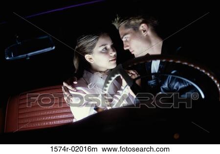 Teenage couple sitting in a car looking at each other View Large Photo Image Picture - Teenage couple sitting in a car looking at each other. Fotosearch