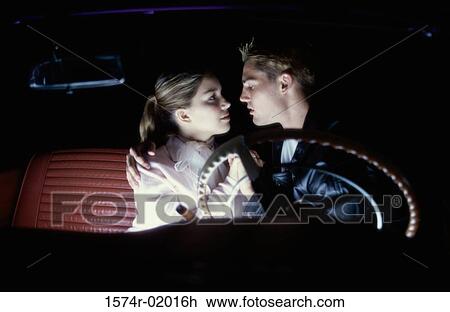 Teenage couple sitting in a car looking at each other View Large Photo Image Stock Image - Teenage couple sitting in a car looking at each other. Fotosearch