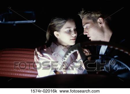 Teenage couple sitting in a car looking at each other View Large Photo Image Stock Image - Teenage couple sitting in a car looking at each other. Fotosearch