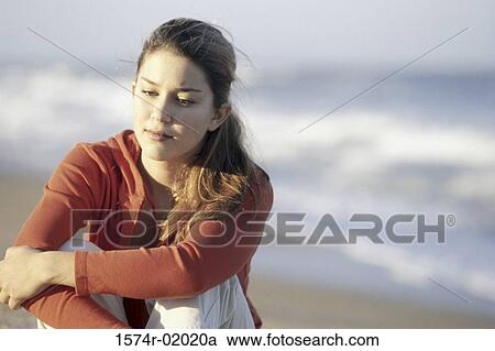 Teenage girl sitting at the beach View Large Photo Image Stock Image - Teenage girl sitting at the beach. Fotosearch
