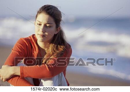 Teenage girl sitting at the beach View Large Photo Image Stock Image - Teenage girl sitting at the beach. Fotosearch