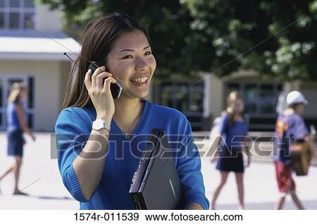 Stock Photo - Teenage girl talking on a mobile phone. Fotosearch