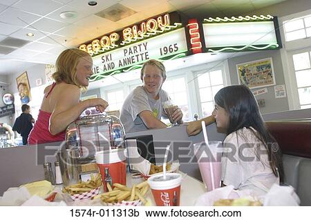 Teenage girls and teenage boys at a restaurant View Large Photo Image Stock Image - Teenage girls and teenage boys at a restaurant. Fotosearch
