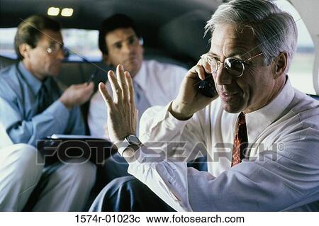 Stock Image - Three businessmen sitting in a car. Fotosearch