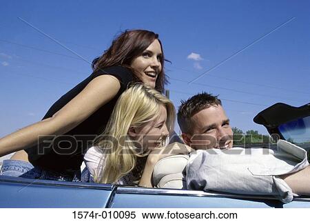 Three young people in a convertible car View Large Photo Image Stock Photography - Three young people in a convertible car. Fotosearch