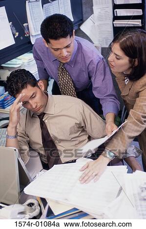 Stock Image - Two businessmen and a businesswoman having a discussion. Fotosearch