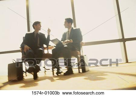 Stock Image - Two businessmen discussing. Fotosearch
