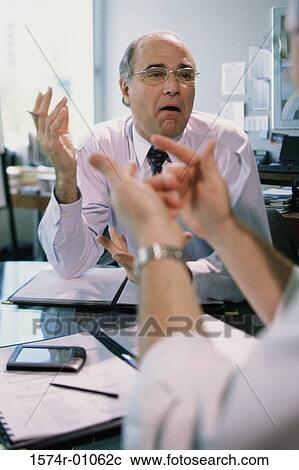 Two businessmen having a discussion View Large Photo Image Stock Image - Two businessmen having a discussion. Fotosearch
