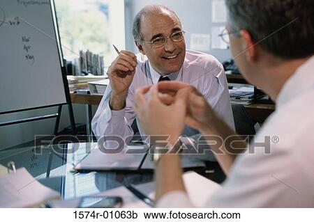 Two businessmen having a discussion View Large Photo Image Stock Image - Two businessmen having a discussion. Fotosearch