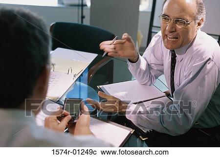 Two businessmen having a discussion View Large Photo Image Stock Image - Two businessmen having a discussion. Fotosearch
