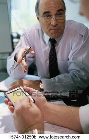 Two businessmen having a discussion View Large Photo Image Stock Image - Two businessmen having a discussion. Fotosearch
