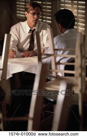 Two businessmen sitting together View Large Photo Image Stock Image - Two businessmen sitting together. Fotosearch