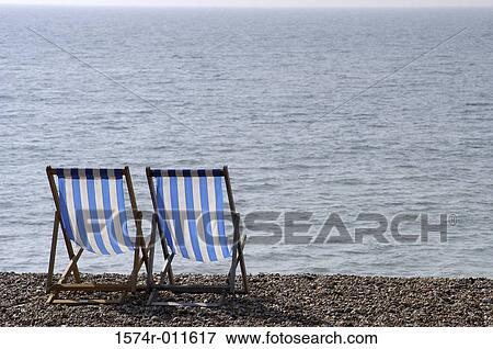 Two deck chairs on the beach View Large Photo Image Stock Photo - Two deck chairs on the beach. Fotosearch