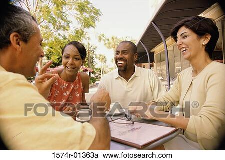 Two mature couples sitting together smiling View Large Photo Image Stock Image - Two mature couples sitting together smiling. Fotosearch