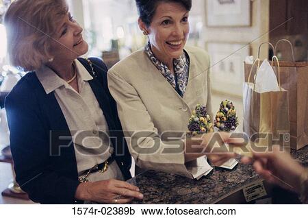Two mature women at a store counter View Large Photo Image Stock Image - Two mature women at a store counter. Fotosearch