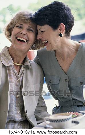 Stock Image - Two mature women laughing. Fotosearch