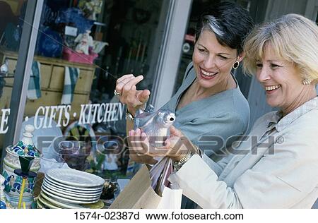 Two mature women shopping in a store View Large Photo Image Stock Image - Two mature women shopping in a store. Fotosearch