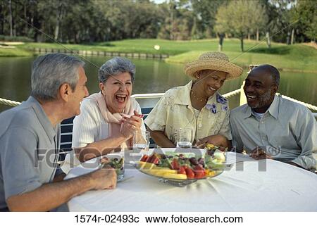 Two senior couples sitting at an outdoor restaurant View Large Photo Image Stock Image - Two senior couples sitting at an outdoor restaurant. Fotosearch