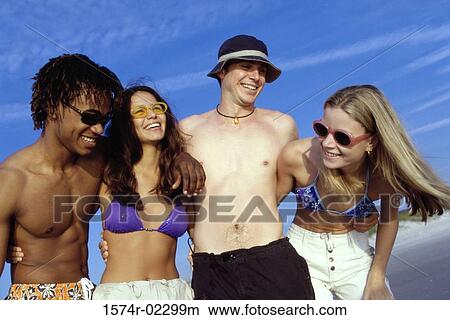 Two teenage couples on the beach View Large Photo Image Picture - Two teenage couples on the beach. Fotosearch