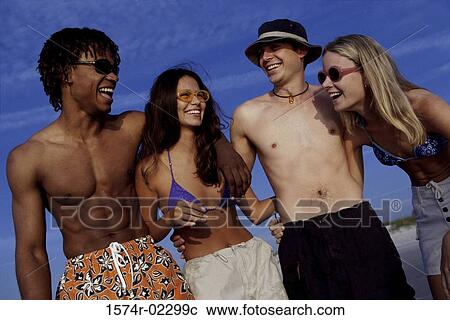 Two teenage couples on the beach View Large Photo Image Stock Image - Two teenage couples on the beach. Fotosearch