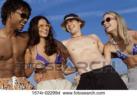 Two teenage couples on the beach View Large Photo Image Stock Image - Two teenage couples on the beach. Fotosearch