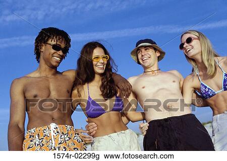 Two teenage couples on the beach View Large Photo Image Stock Image - Two teenage couples on the beach. Fotosearch