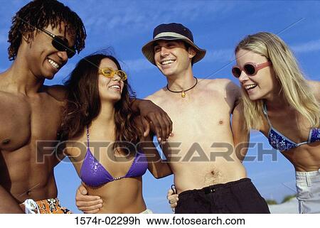 Two teenage couples on the beach View Large Photo Image Stock Image - Two teenage couples on the beach. Fotosearch
