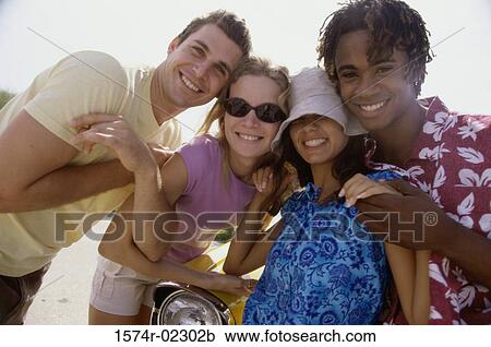 Stock Image - Two teenage couples on the beach. Fotosearch