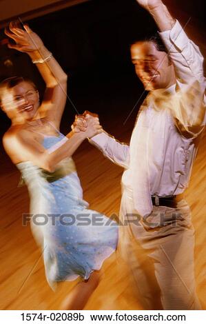 Stock Image - Young couple dancing together. Fotosearch