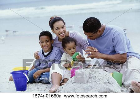 Young couple on the beach with their son and daughter View Large Photo Image Stock Image - Young couple on the beach with their son and daughter. Fotosearch