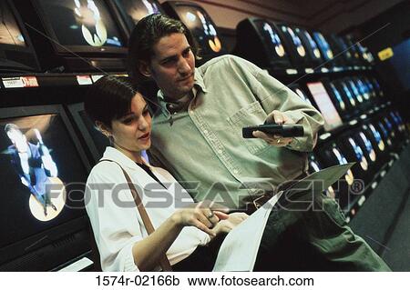 Young couple shopping for a television View Large Photo Image Stock Image - Young couple shopping for a television. Fotosearch